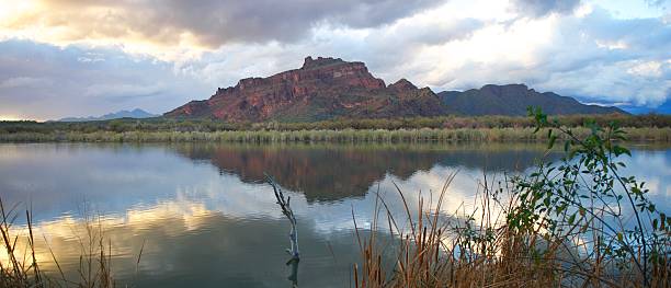 istock Beautiful Green Desert Mountains with calm river and rain clouds 121701848