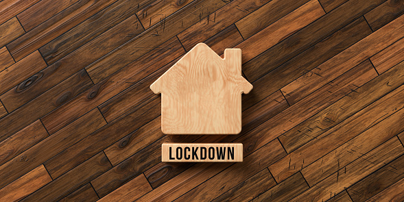 wooden house symbol with text LOCKDOWN on wooden background - 3D rendered illustration