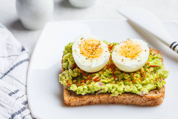 istock Breakfast avocado toast with egg on a white plate. 1217019978