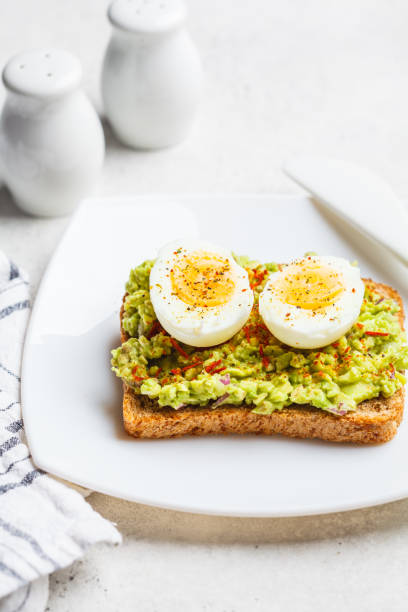 istock Breakfast avocado toast with egg on a white plate. 1217019989