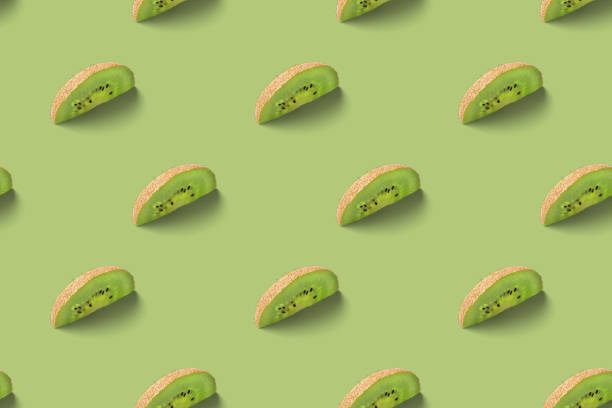 istock Kiwi slices pattern on a green background. Food texture. Kiwi seamless texture. 1217019992