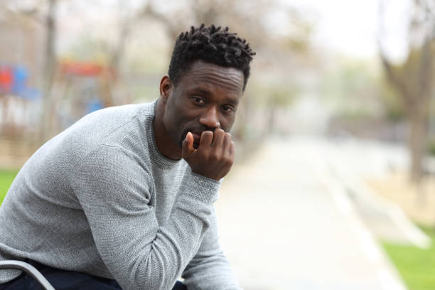 istock Serious black man looking at camera in the park 1217020206