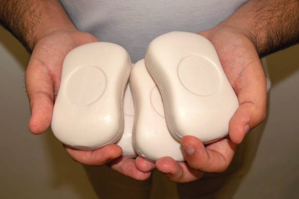 istock Man holds many soap bars in his hands 1217020387