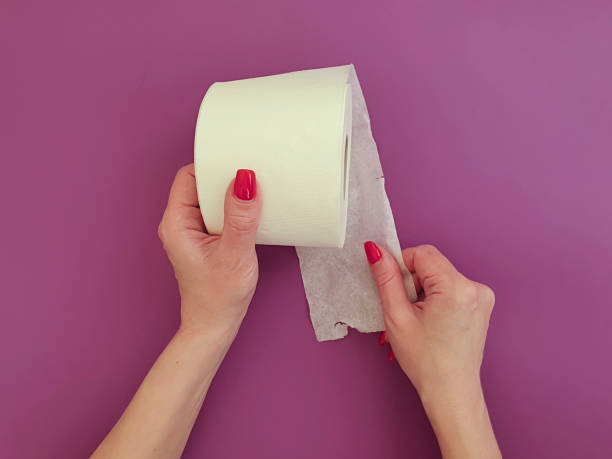 istock female hands with toilet paper on a colored background 1217020580