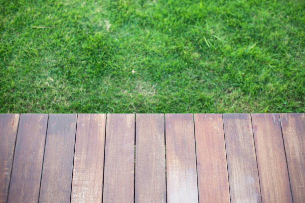 istock Wooden table or wooden mockup over grass. 1217021229