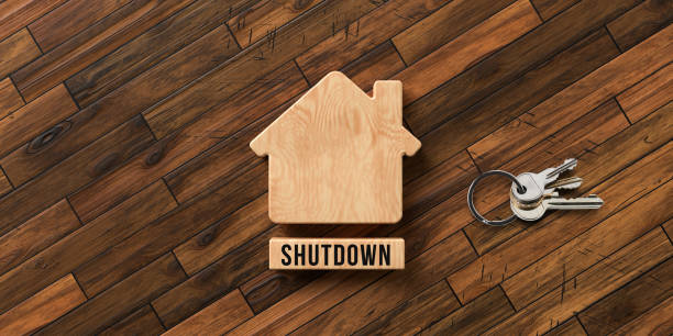 istock wooden house symbol with text SHUTDOWN - 3D rendered illustration 1217021571