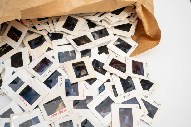 Disposing of Old Photographic Slides Close-up of old photographic slides spilling out of brown paper bag. Concept of outdated technology. projection equipment photos stock pictures, royalty-free photos & images
