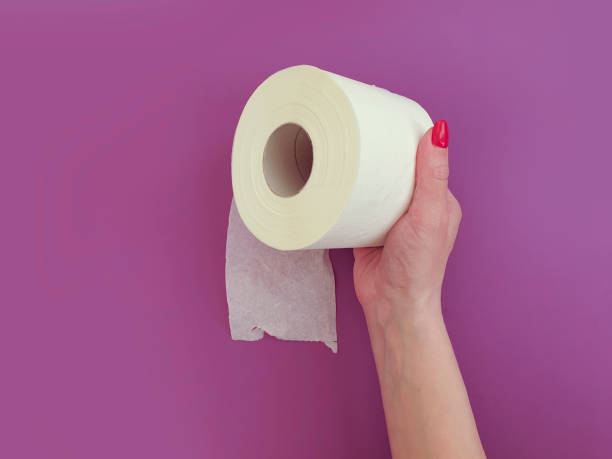 istock female hands with toilet paper on a colored background 1217022998