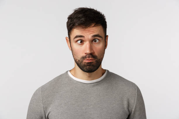 istock Emotions, people concept. Funny and goofy cute bearded guy making crazy eyes, squinting and grimacing, pouting, standing playful, trying make friends laugh, standing white background 1217023367