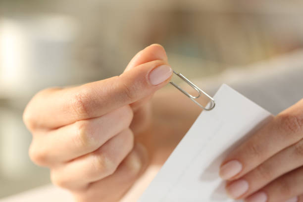 istock Woman putting a paper clip on document sheets 1217024031
