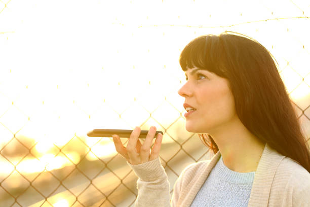 istock Woman recording message using voice recognition on phone 1217024656