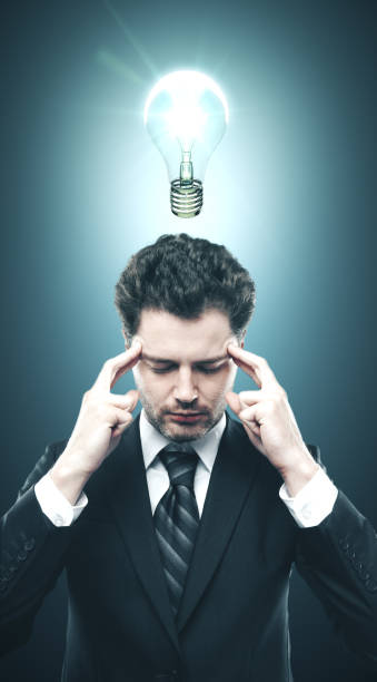 istock Businessman in suit thinking with lightbulb over head 1217024697