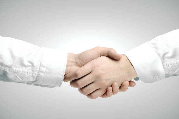 istock Close up of handshake on gray  background. 1217024787