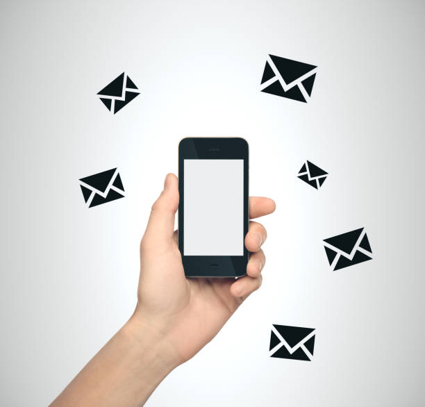 istock Hand holding smartphone with email sign 1217026124