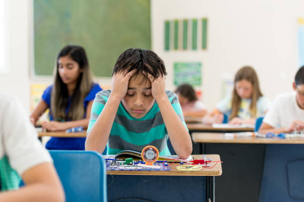 istock Elementary School Boy At Desk Learning stock photo 1217026543