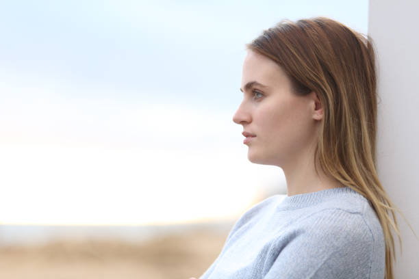 istock Serious pensive woman looking away on the beach 1217026774