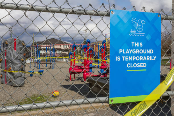 istock Playground Closed sign on chain link fence 1217026857