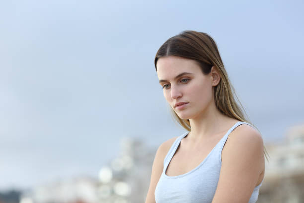 istock Sad woman looking down in the street 1217027367