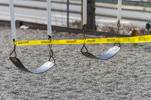 A set of swings are caution taped off during COVID-19 prevention measures.