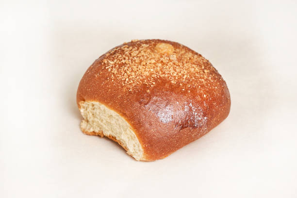 istock Fresh bread loaf sprinkled with grated walnut. Closeup on a light background. Delicious and healthy range of bakery and bakery 1217027573