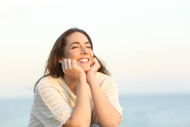 istock Satisfied woman smiling enjoying a beach day 1217027716