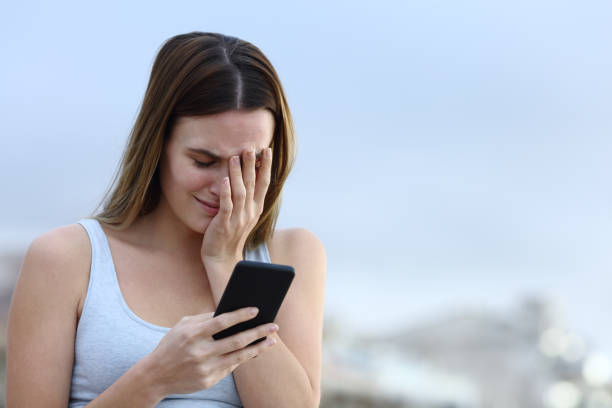 istock Sad woman crying checking mobile phone 1217027740