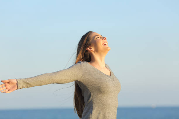 istock Happy woman celebrating good day on the beach 1217028268