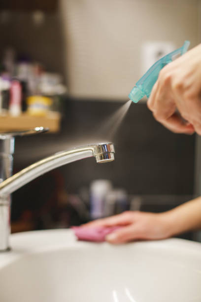 istock Woman cleaning bathroom 1217028981