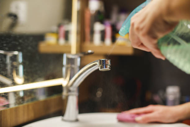 istock Woman cleaning bathroom 1217028983