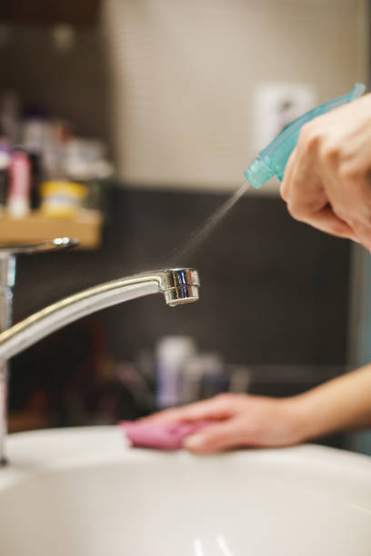 istock Woman cleaning bathroom 1217029125