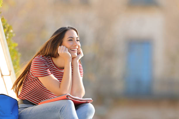 istock Candid pensive happy student looks away in a campus 1217029380