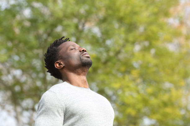 istock Black serious man breathing fresh air in a park 1217030745