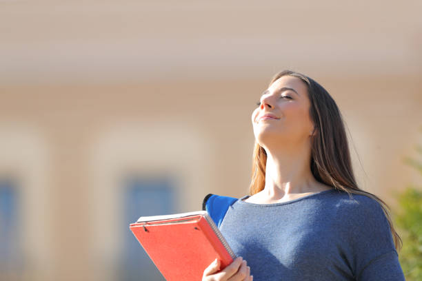 istock Happy student breathing fresh air in a campus 1217031297