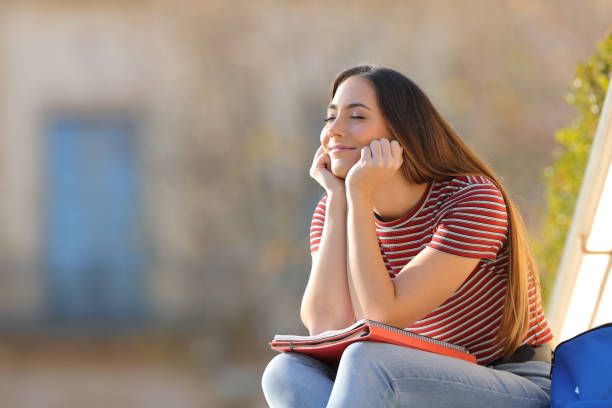 istock Happy student relaxing sitting in a campus 1217031495