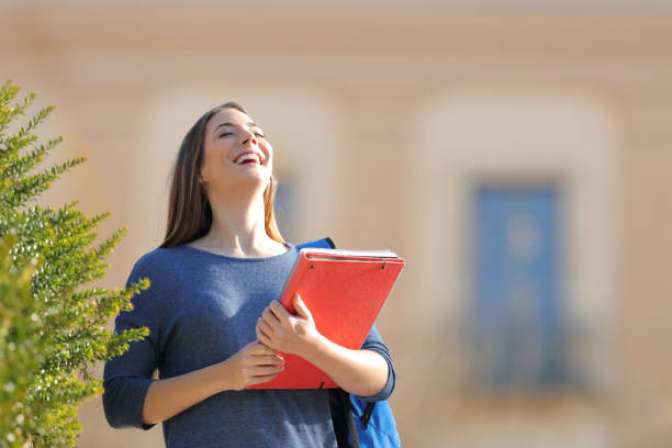 istock Happy student breathing fresh air in an university campus 1217031543