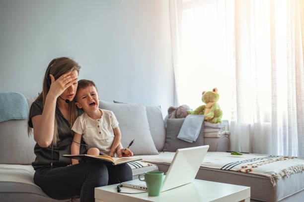 Single mother with a baby trying to work.