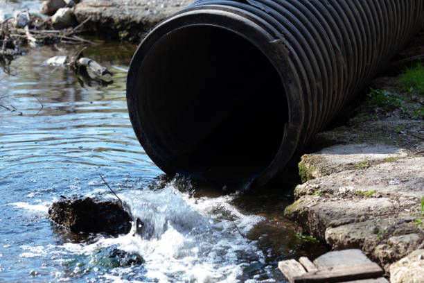 istock Pipe from which toxic waste spills into the river 1217031872