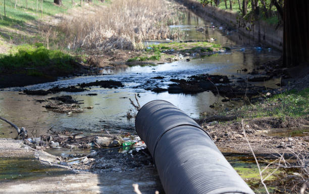 istock Pipe from which toxic waste spills into the river 1217031923