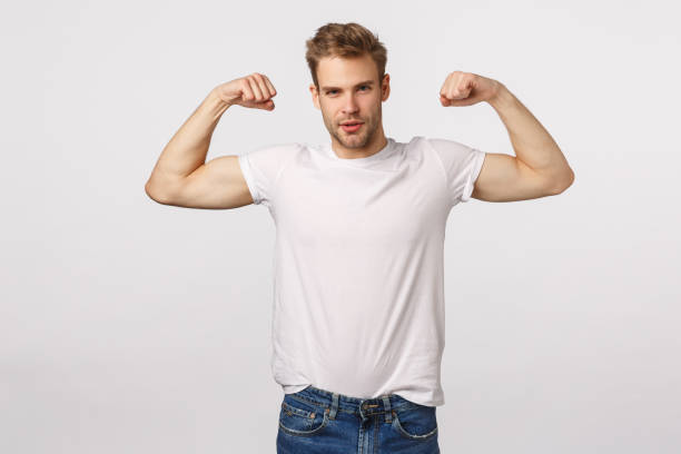 istock Masculine confident and sassy blond bearded caucasian man, standing white background with flexed biceps, be in good shape, workout and bragging, being boastful own body shape or strength 1217033859