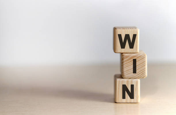 istock WIN - text on wooden cubes, on white background 1217035374