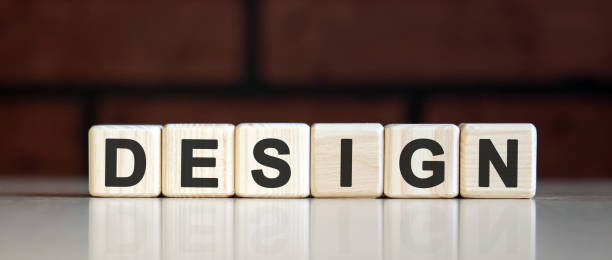 istock DESIGN - art concept on on a dark brick background. Wooden cubes with text 1217035385