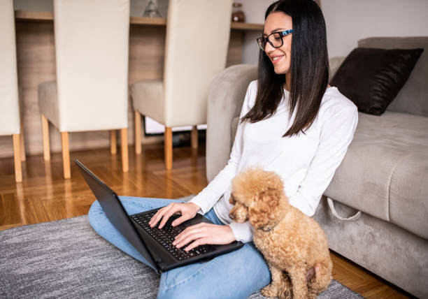 istock Young woman working at home with her pet. 1217035454
