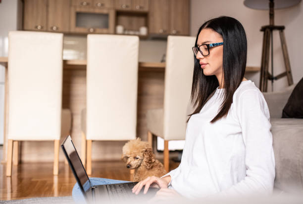 istock Young woman working at home with her pet. 1217035485
