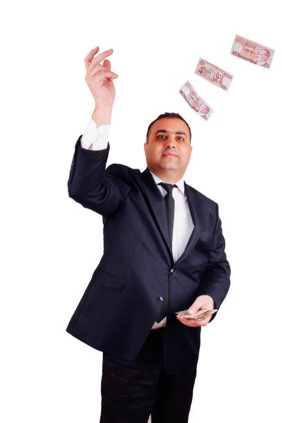 istock Businessman in formal wear throws up paper money. Isolate 1217036172