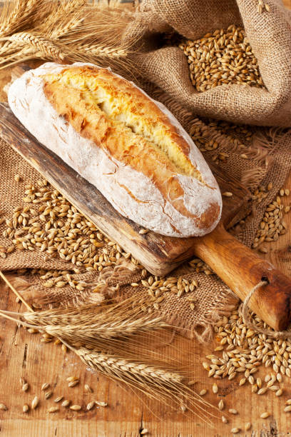 istock Freshly baked bread on wooden cutting board 1217036391