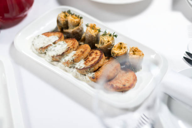 istock Seafood. Fish cakes and cheese rolls stuffed with fish fillet on a plate on a white background 1217037561