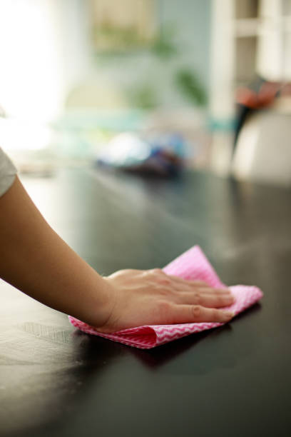 istock Woman cleaning dining table at home 1217038000