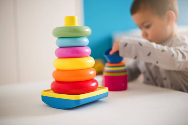 istock Toddler playing with plastic baby toy 1217038978