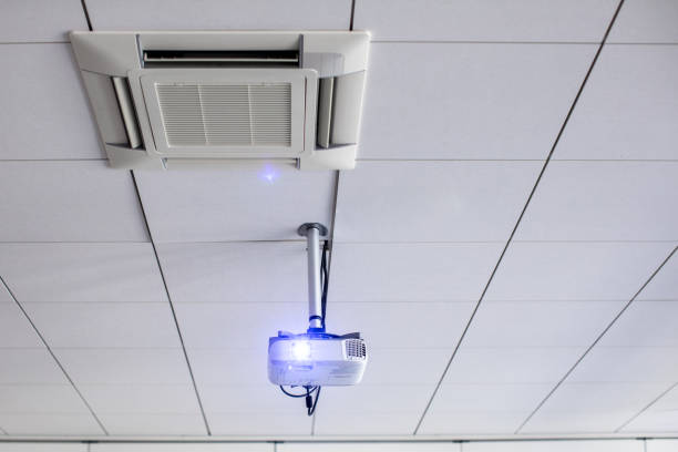 istock A white overhead projector on ceiling in a conference room 1217040309