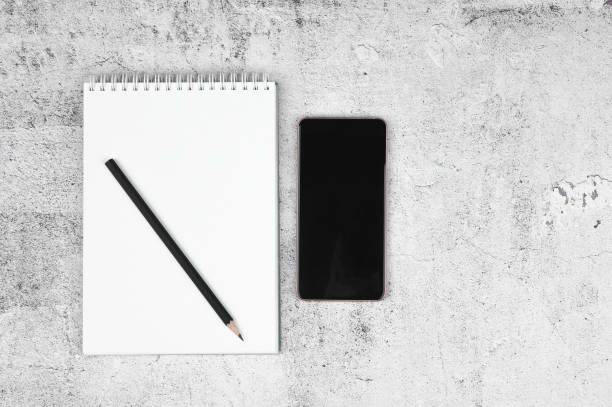istock Home office. Open Notebook and Pencil on Work Desk. Wooden background 1217041651